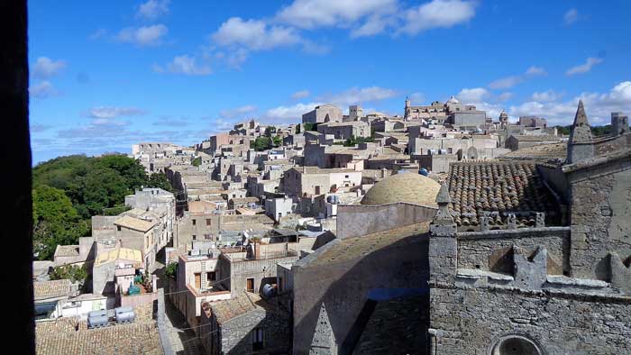 The Chiesa Madre of Erice with its medieval bell tower in the mist, with the rooftops of the village and the sea visible below